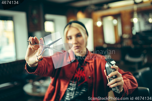 Image of Female barber in barber shop