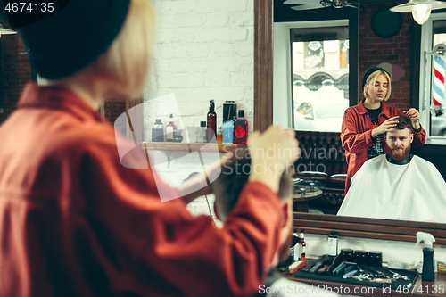 Image of Client during beard shaving in barber shop