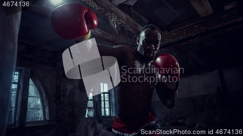 Image of Hand of boxer over black background. Strength, attack and motion concept