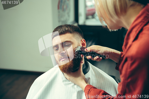 Image of Client during beard shaving in barber shop