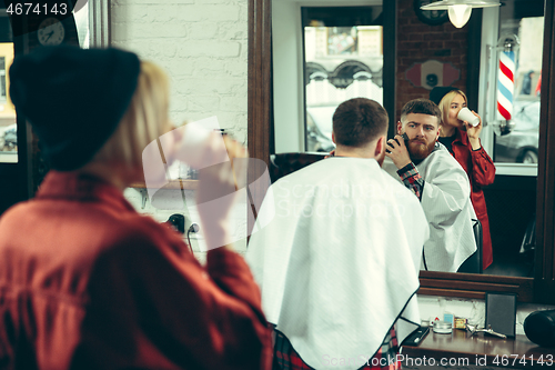 Image of Client during beard shaving in barber shop