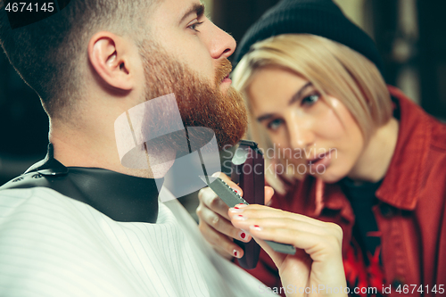 Image of Client during beard shaving in barber shop