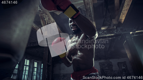 Image of Hand of boxer over black background. Strength, attack and motion concept