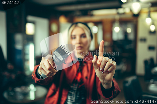 Image of Female barber in barber shop