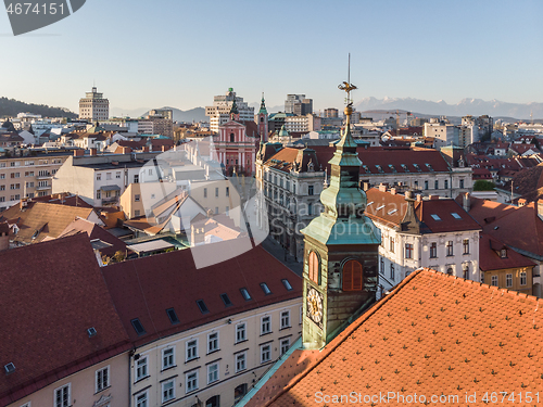 Image of Scenic panoramic aerial drone view of rooftops of medieval city center, town hall and cathedral church in Ljubljana, capital of Slovenia, at sunset