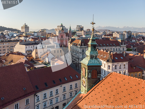 Image of Scenic panoramic aerial drone view of rooftops of medieval city center, town hall and cathedral church in Ljubljana, capital of Slovenia, at sunset