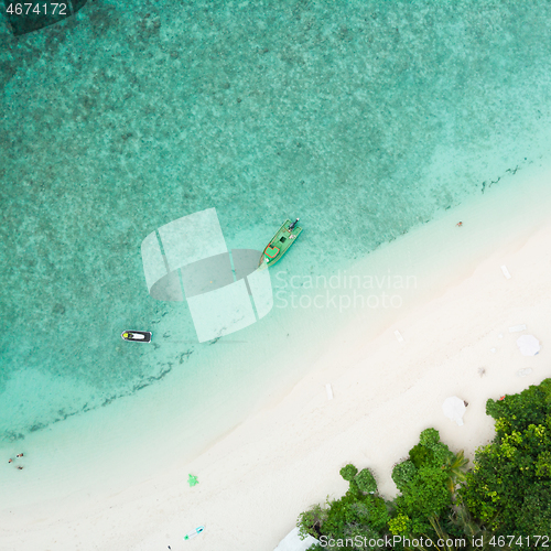 Image of Aerial drone view of picture perfect beach and turquoise lagoon on small tropical island on Maldives