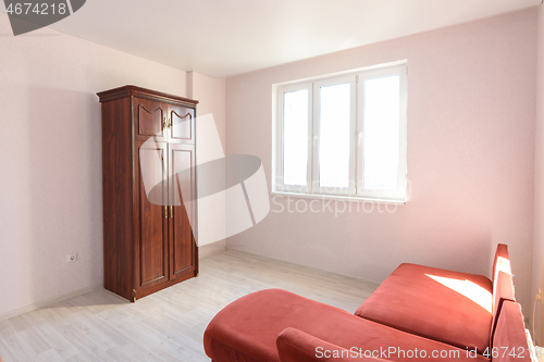 Image of Interior of a non-residential room empty for sale with several pieces of furniture