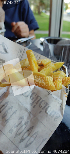 Image of Home made fresh french fries on the table in restaurant