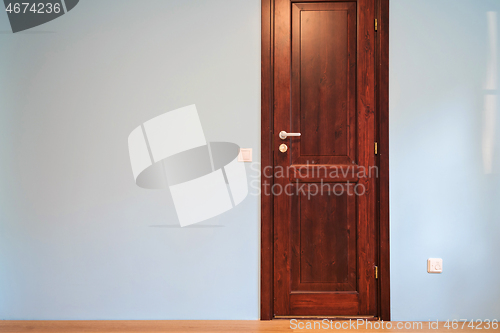 Image of Frontal view to the wooden door in home interior