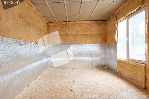 Image of Interior of a country house, a heat-insulating layer of reflective polyethylene foam laminated with lavsan when insulating a house