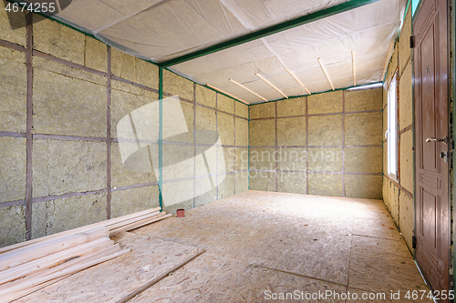 Image of The interior of a suburban room under construction, insulated from the inside with soft thermal insulation