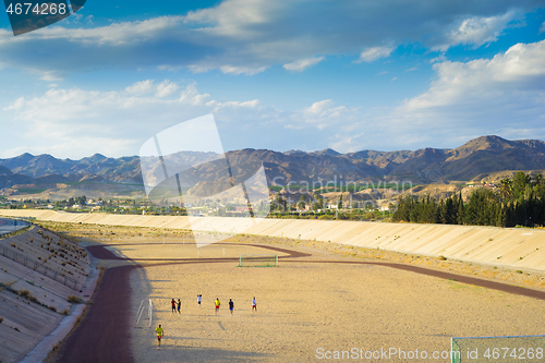 Image of ANDALUSIA, SPAIN - APRIL 24, 2014: A football field on the mountain s on tha background.