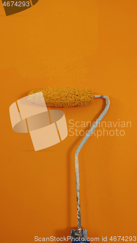 Image of A paint roller against the wall