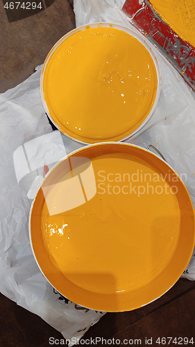 Image of Paint can with orange paint