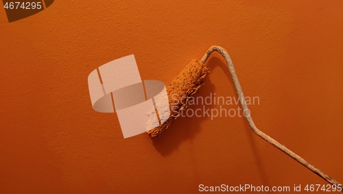 Image of A paint roller against the wall