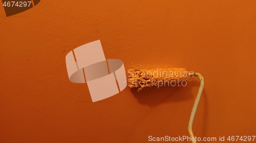 Image of A paint roller against the wall