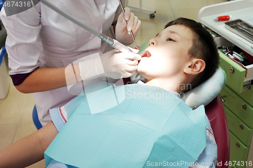 Image of Dentist examining boy mouth