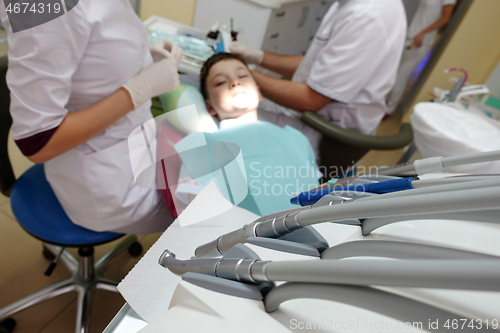 Image of Dentist examining boy mouth