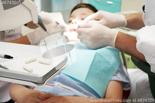 Image of Dentist examining boy mouth