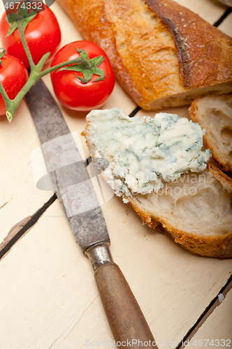 Image of fresh blue cheese spread ove french baguette