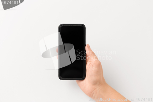 Image of close up of hand with black smartphone