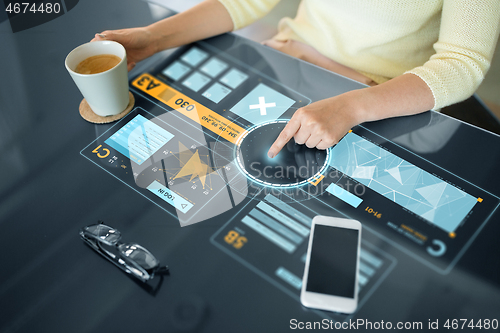 Image of woman using interactive panel with data