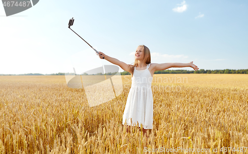 Image of happy young girl taking selfie by smartphone