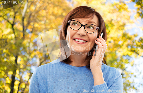 Image of senior woman in glasses calling on smartphone