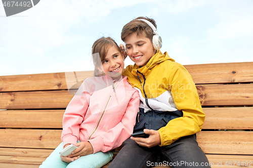 Image of bou and girl with headphones listening to music