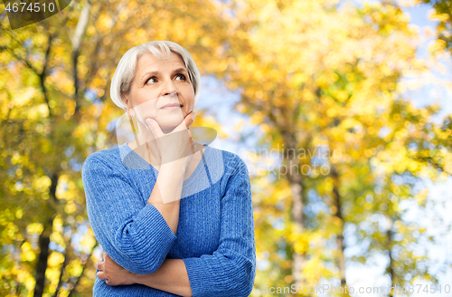 Image of portrait of senior woman thinking in autumn park