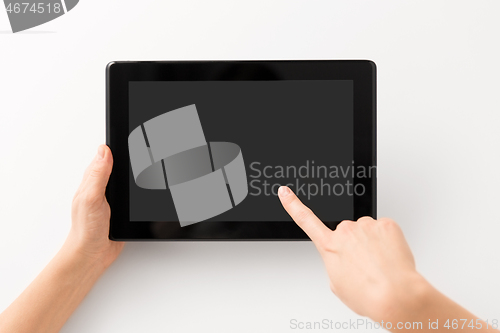 Image of close up of hands with black tablet computer