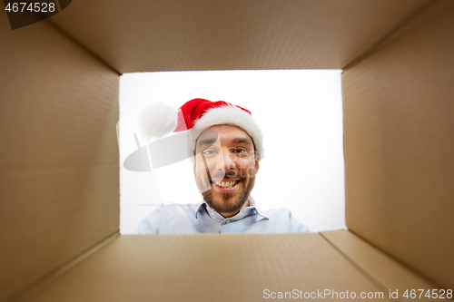 Image of happy man opening parcel box or christmas gift