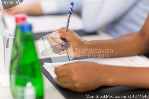 Image of hands of businesswoman at business conference