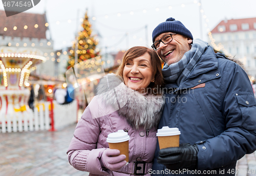 Image of senior couple with coffee at christmas market