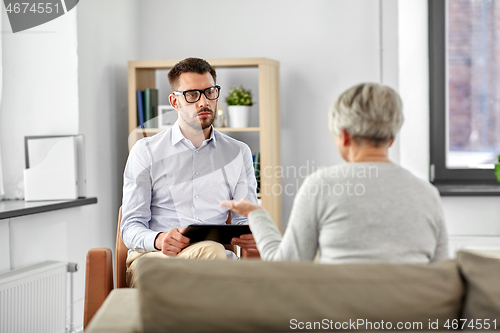 Image of psychologist listening to senior woman patient