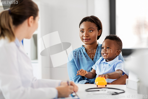 Image of happy mother with baby son and doctor at clinic