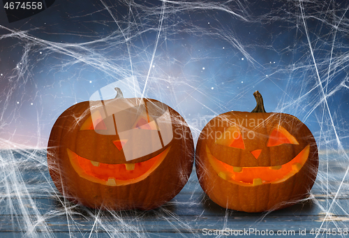 Image of two pumpkins or jack o lanterns and spiderweb