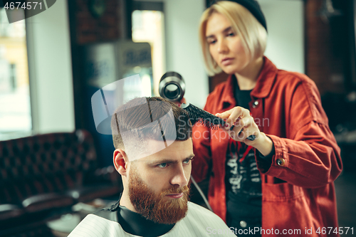 Image of Client during beard shaving in barber shop