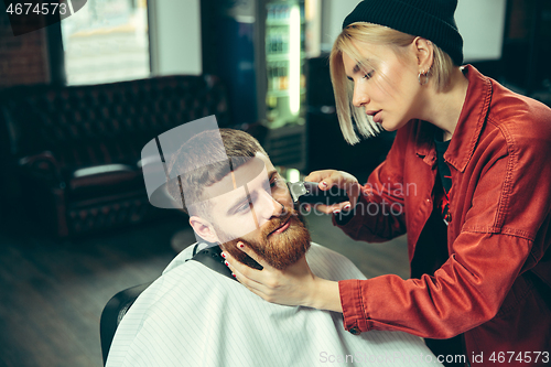 Image of Client during beard shaving in barber shop