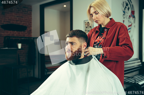 Image of Client during beard shaving in barber shop