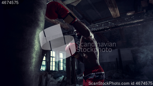 Image of Hand of boxer over black background. Strength, attack and motion concept