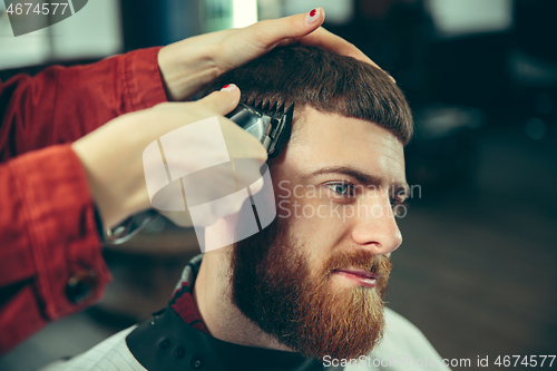 Image of Client during beard shaving in barber shop