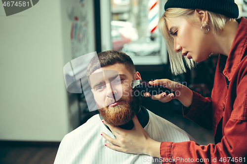 Image of Client during beard shaving in barber shop