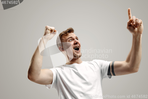 Image of Winning success man happy ecstatic celebrating being a winner. Dynamic energetic image of male model