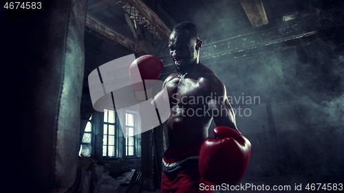 Image of Hand of boxer over black background. Strength, attack and motion concept