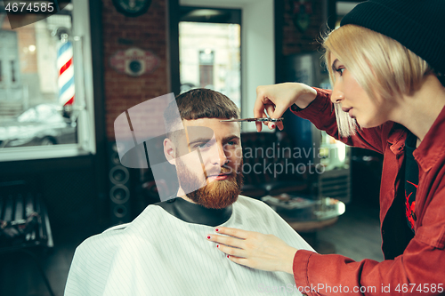 Image of Client during beard shaving in barber shop