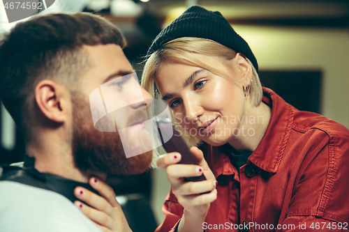 Image of Client during beard shaving in barber shop