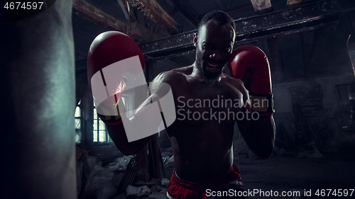 Image of Hand of boxer over black background. Strength, attack and motion concept