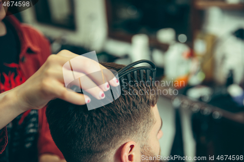 Image of Client during beard shaving in barber shop